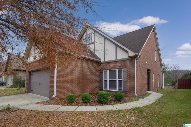 view of side of home featuring a garage and a lawn