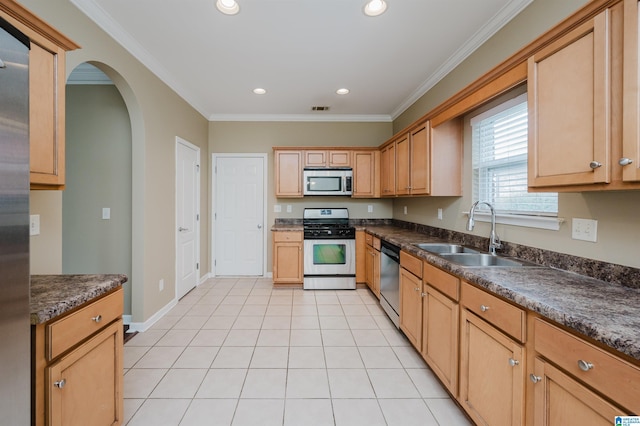 kitchen featuring sink, light tile patterned floors, stainless steel appliances, and ornamental molding