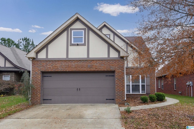 tudor-style house featuring a garage