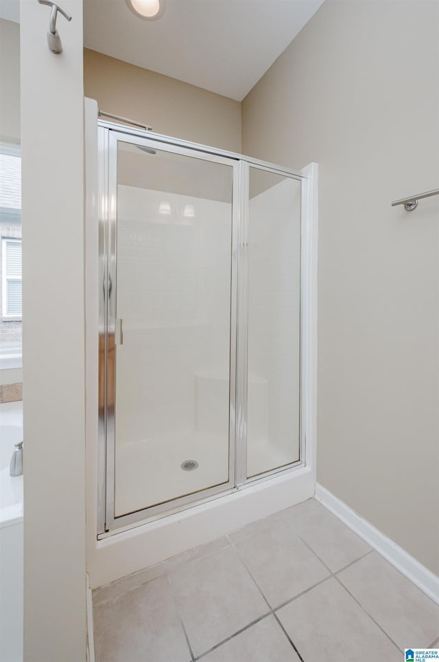 bathroom featuring tile patterned flooring and a shower with door