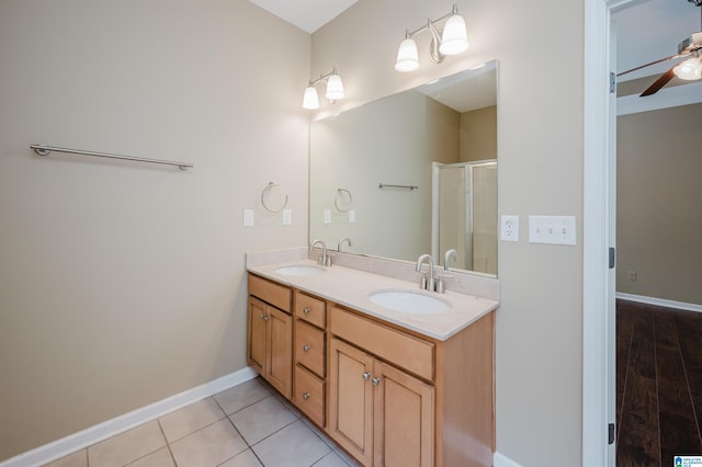 bathroom featuring tile patterned flooring, vanity, ceiling fan, and walk in shower