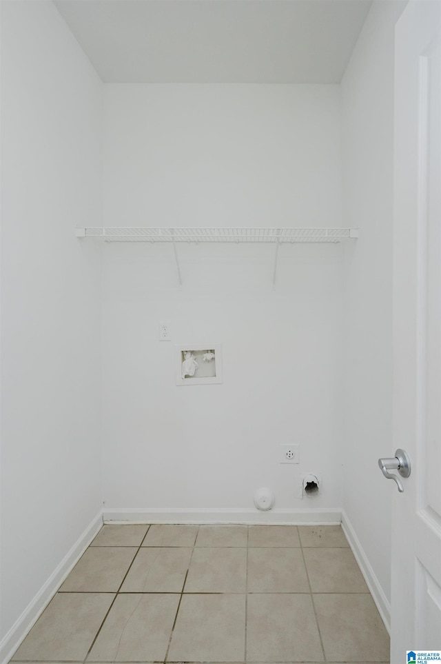 washroom with washer hookup, hookup for a gas dryer, light tile patterned floors, and electric dryer hookup