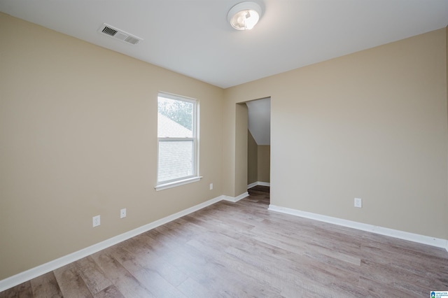 empty room with light hardwood / wood-style flooring