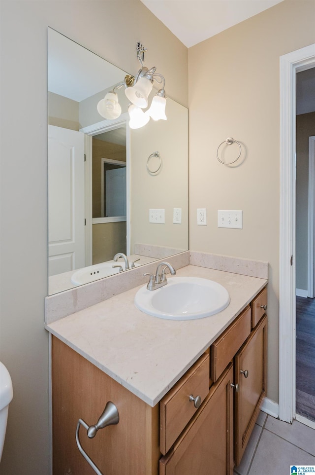 bathroom with tile patterned floors, vanity, and a notable chandelier