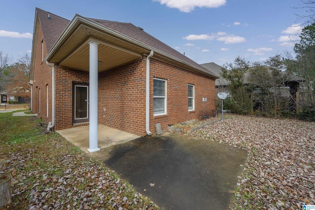 view of side of property featuring a patio area