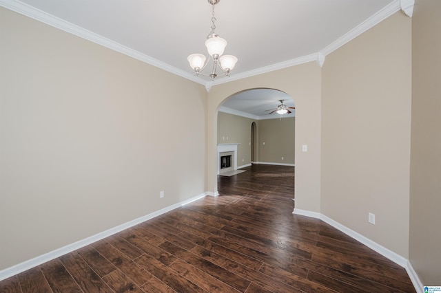 unfurnished dining area featuring dark hardwood / wood-style floors, ornamental molding, and ceiling fan with notable chandelier