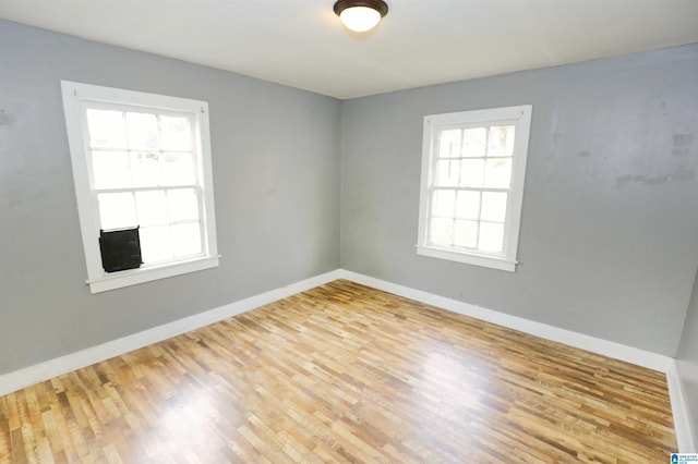 unfurnished room with a healthy amount of sunlight and light wood-type flooring