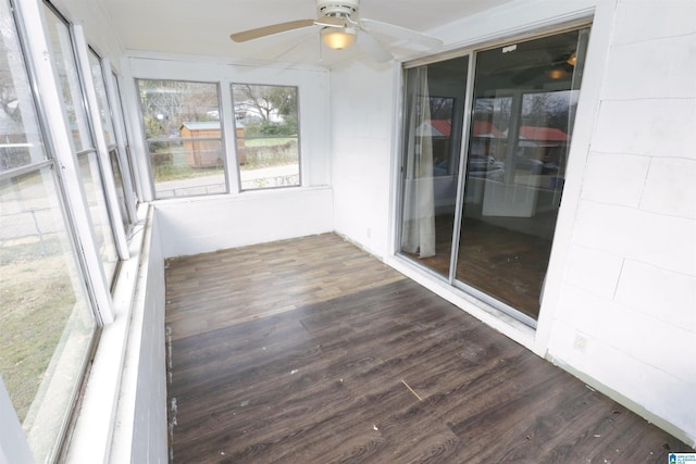 unfurnished sunroom featuring ceiling fan