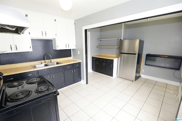 kitchen with sink, electric range, range hood, white cabinetry, and stainless steel refrigerator