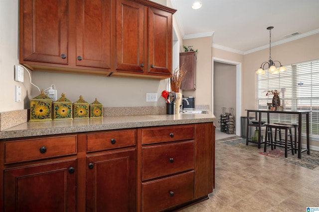 kitchen with sink, an inviting chandelier, pendant lighting, and ornamental molding