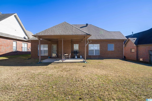 rear view of property with a lawn and a patio area