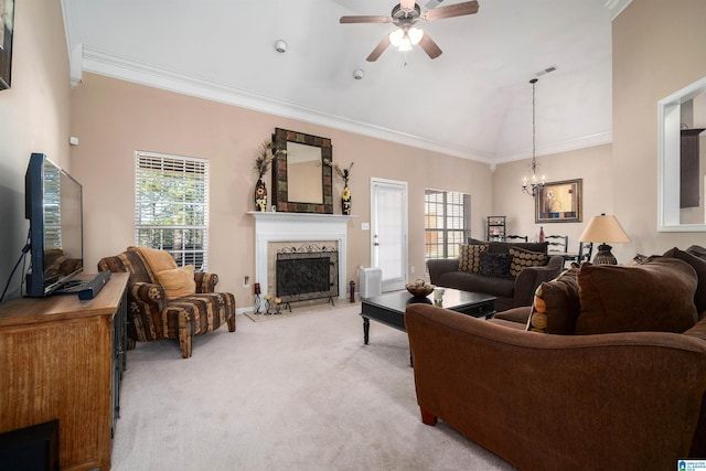 carpeted living room featuring ceiling fan with notable chandelier, vaulted ceiling, ornamental molding, and a premium fireplace