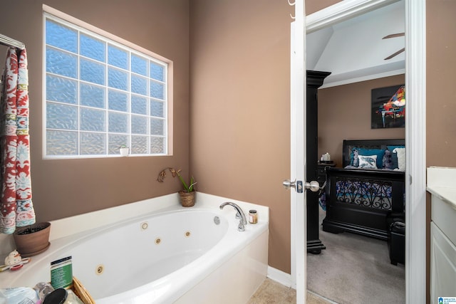 bathroom featuring vanity, crown molding, and a bath