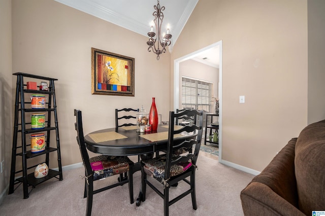 dining space with lofted ceiling, light colored carpet, an inviting chandelier, and ornamental molding