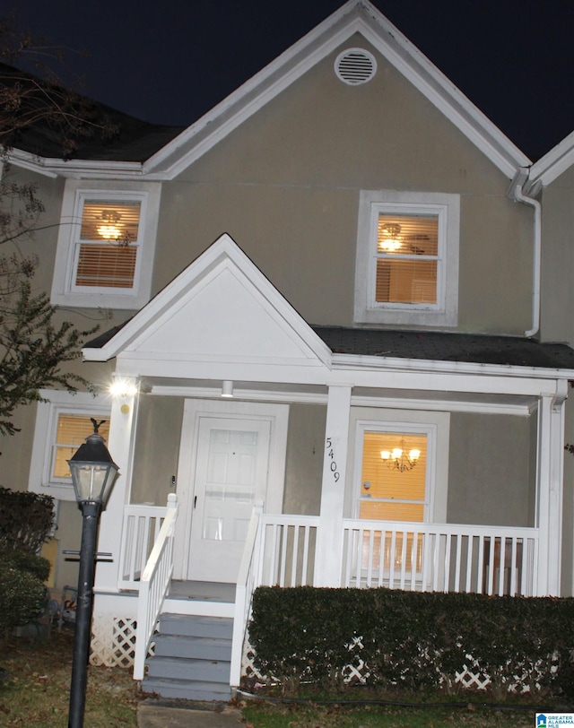 exterior entry at night with a porch