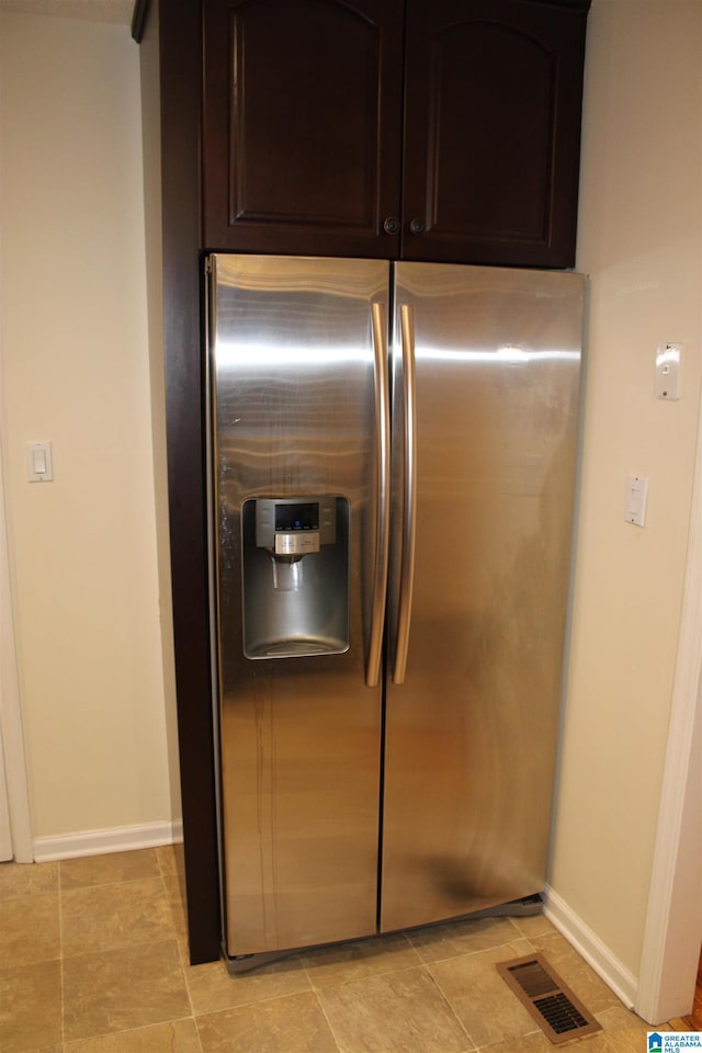 kitchen with dark brown cabinetry and stainless steel refrigerator with ice dispenser