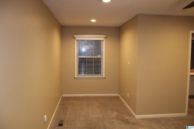 unfurnished room featuring carpet