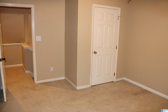 unfurnished bedroom with light colored carpet