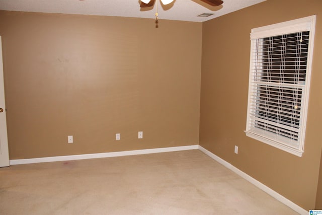 unfurnished room featuring carpet, a textured ceiling, and ceiling fan