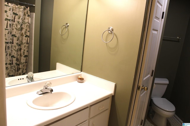 bathroom with vanity, toilet, and walk in shower