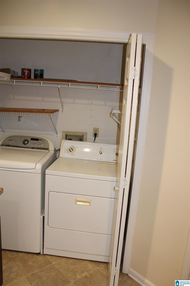 laundry room featuring independent washer and dryer and light tile patterned floors