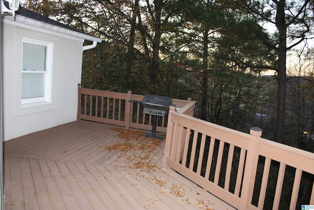 wooden terrace featuring a grill