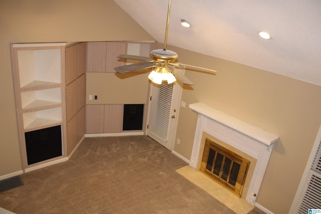 unfurnished living room with carpet, ceiling fan, and vaulted ceiling