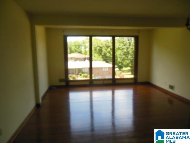 spare room with wood-type flooring