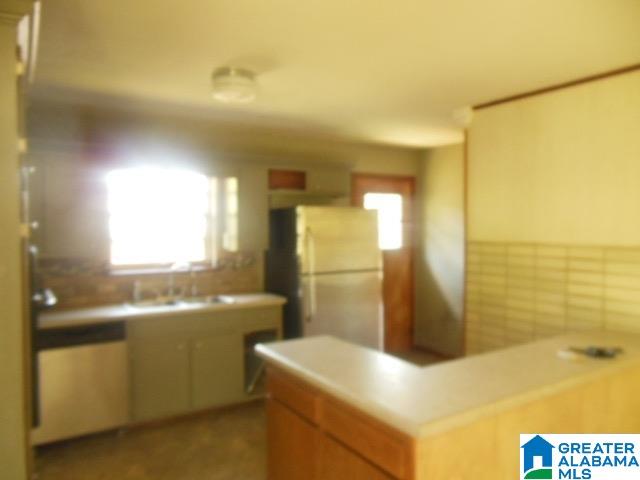 kitchen featuring white fridge and sink