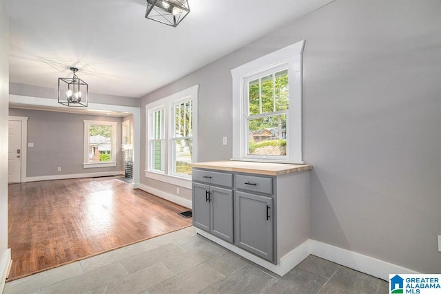 interior space featuring light hardwood / wood-style flooring, a healthy amount of sunlight, and a notable chandelier