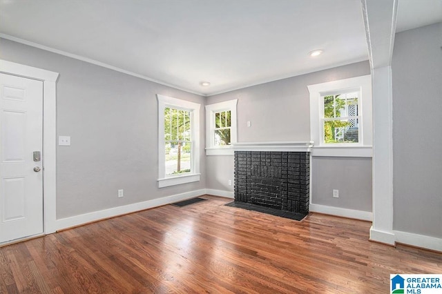 unfurnished living room featuring a fireplace and hardwood / wood-style floors