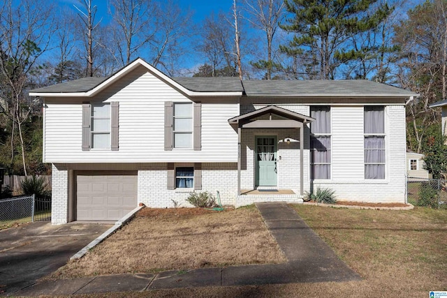 split foyer home featuring a garage and a front lawn