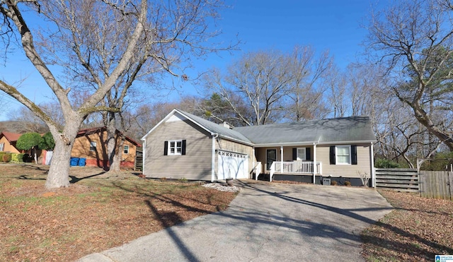 single story home with a porch and a garage