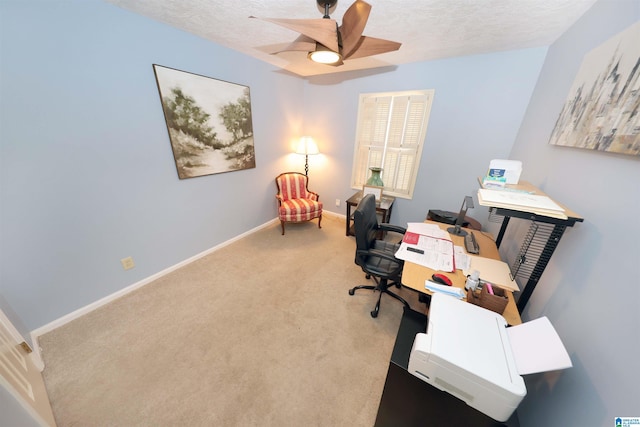 carpeted home office featuring ceiling fan and a textured ceiling