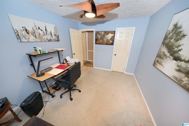 office area featuring light carpet, a textured ceiling, and ceiling fan