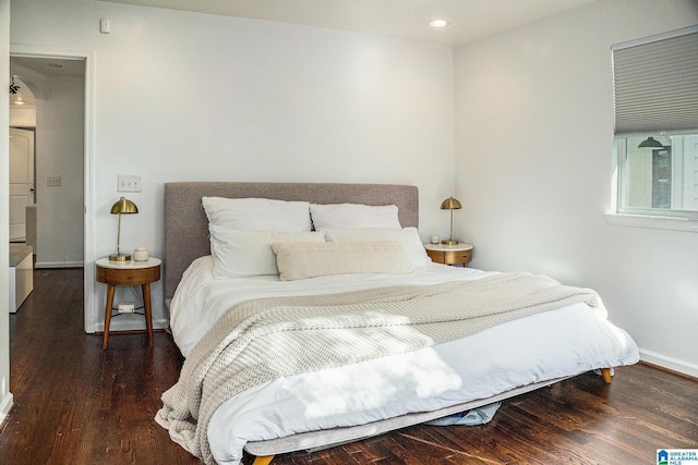 bedroom with dark wood-type flooring