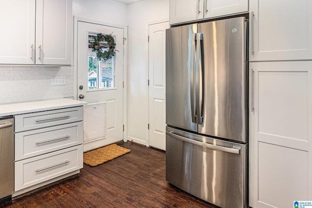 kitchen with white cabinets, appliances with stainless steel finishes, and dark hardwood / wood-style floors