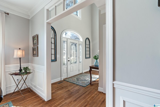 foyer entrance featuring ornamental molding and hardwood / wood-style flooring