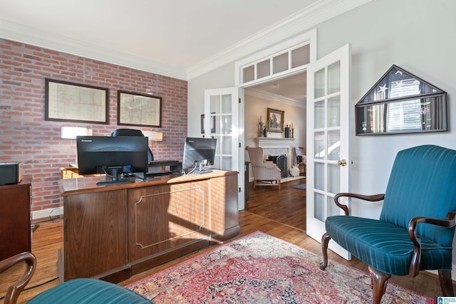 office space with hardwood / wood-style floors, french doors, and brick wall