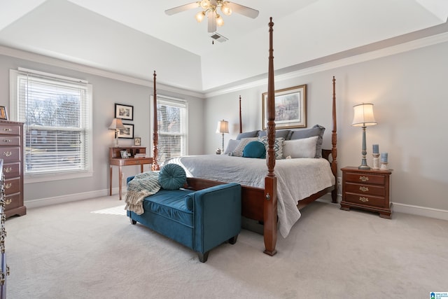 bedroom featuring a tray ceiling, multiple windows, ceiling fan, and light colored carpet