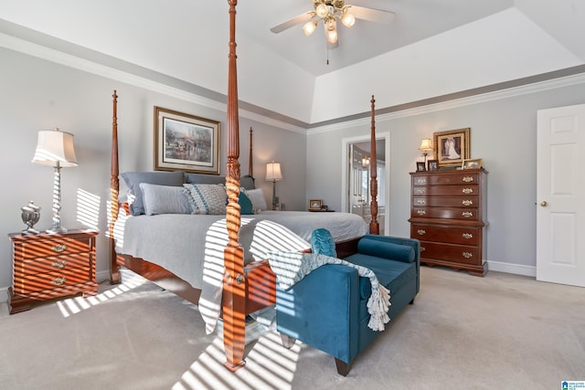 carpeted bedroom with a tray ceiling, ceiling fan, and ornamental molding