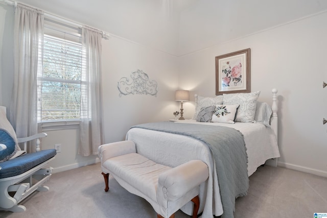 bedroom with multiple windows and light colored carpet