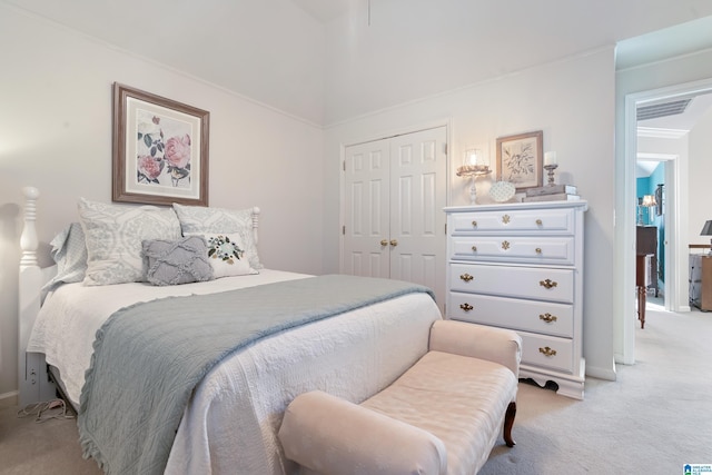 carpeted bedroom with a closet and ornamental molding