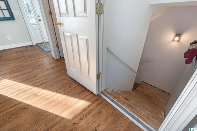 stairs with hardwood / wood-style floors