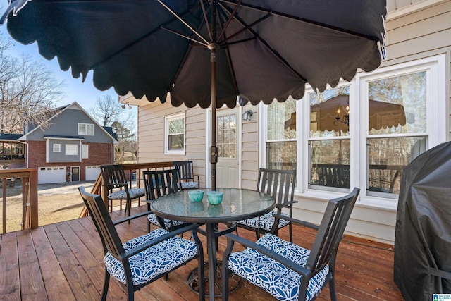 wooden terrace featuring a grill