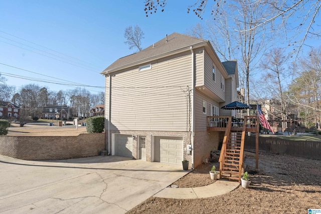 view of side of home with a garage and a deck