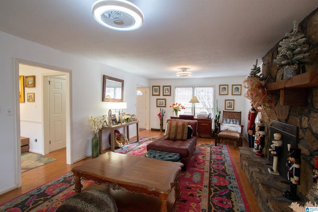 living room featuring wood-type flooring and a textured ceiling