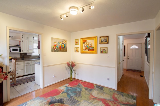 interior space featuring light hardwood / wood-style floors and a textured ceiling