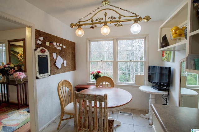 dining area with light tile patterned floors