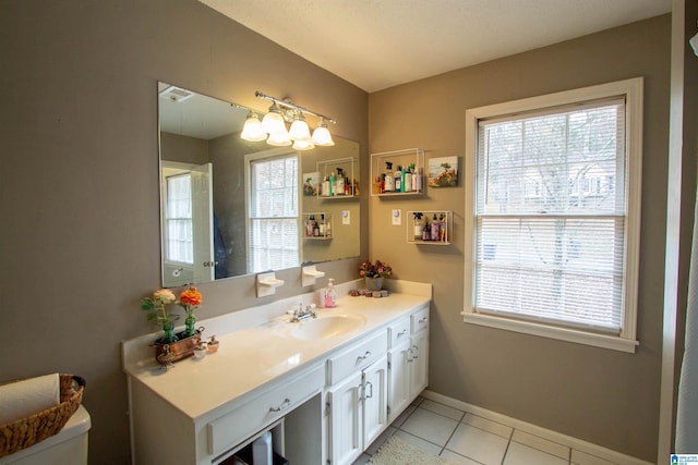 bathroom featuring tile patterned flooring, vanity, and a healthy amount of sunlight